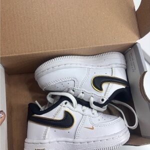 Nike White Sneakers with Black and Gold Accents